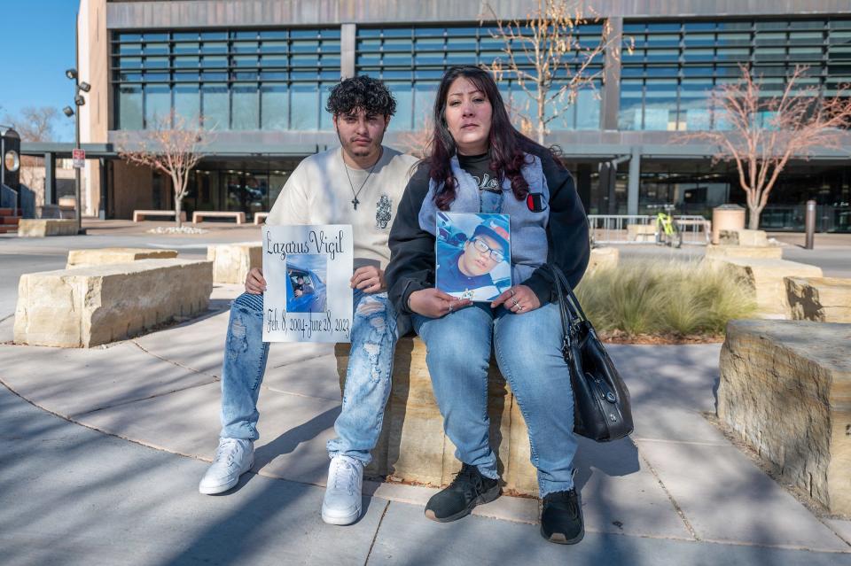 Regina Vigil, right, and Nicodemus Vigil hold photos of their son and brother Lazarus Vigil who was murdered this year in Pueblo.